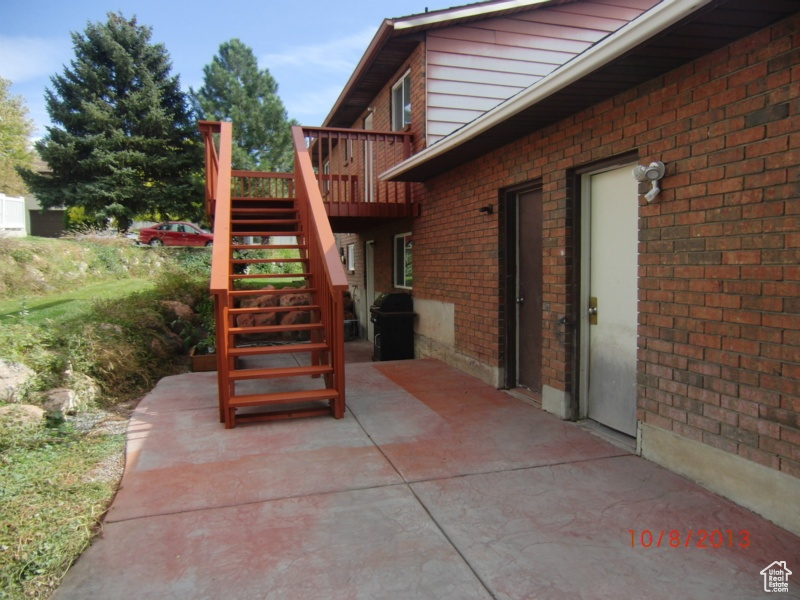 View of patio / terrace with stairs, a wooden deck, and grilling area