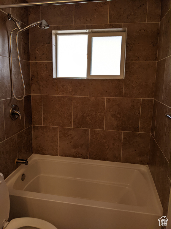 Full bath featuring toilet and bathtub / shower combination