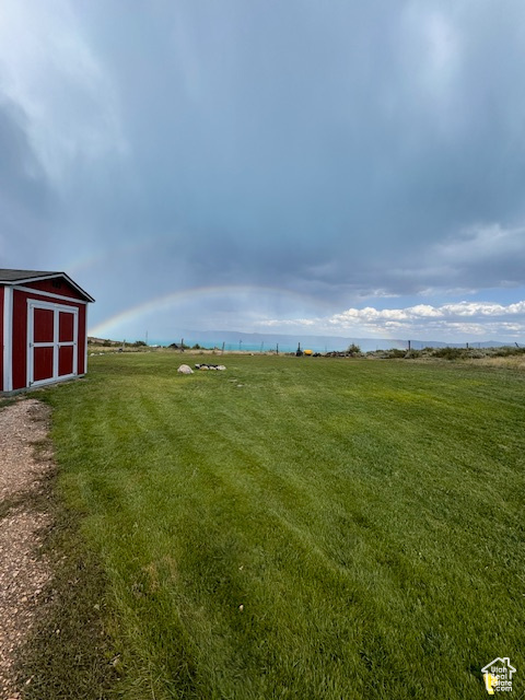 View of green lawn with a rural view