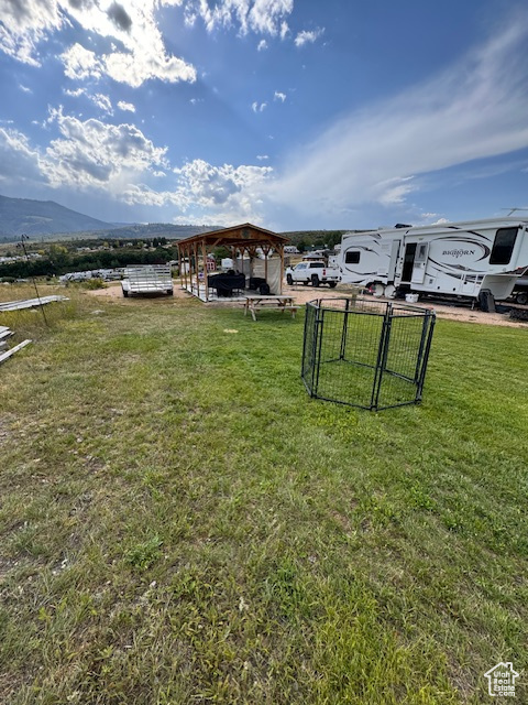 View of grassy yard with a mountain view