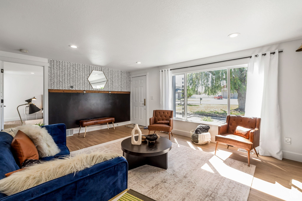 Living room featuring wood finished floors, recessed lighting, and baseboards