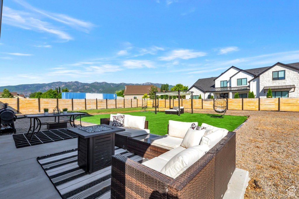 View of patio with an outdoor hangout area and a mountain view