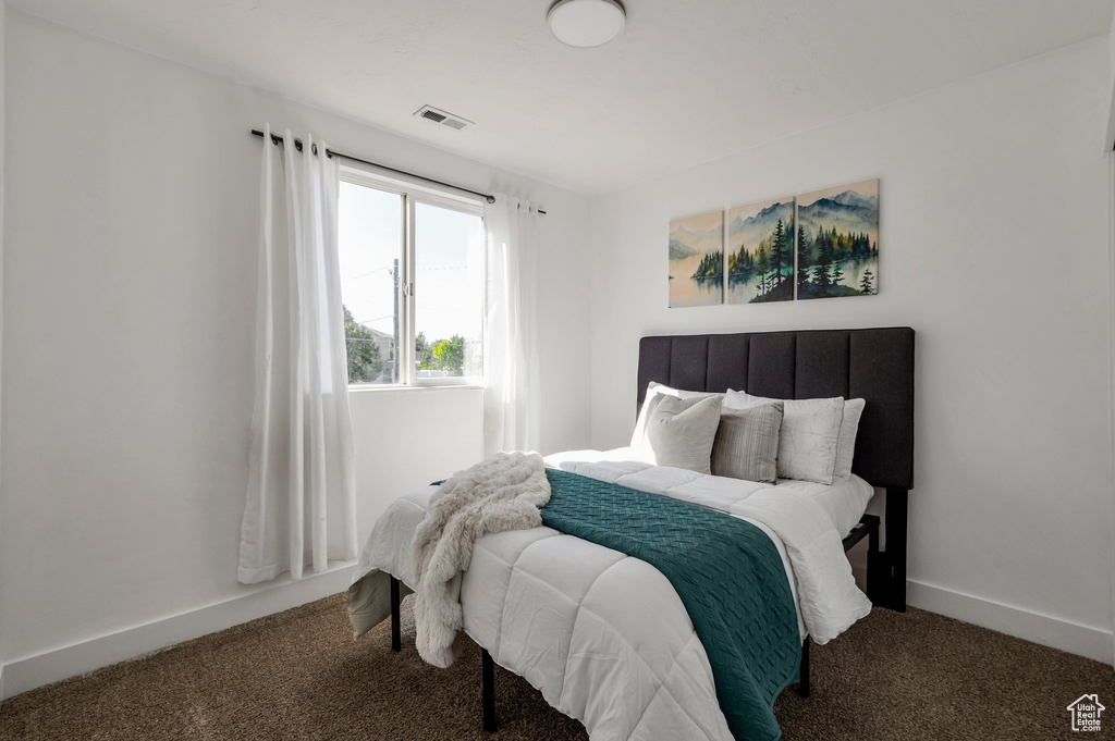 Carpeted bedroom with baseboards