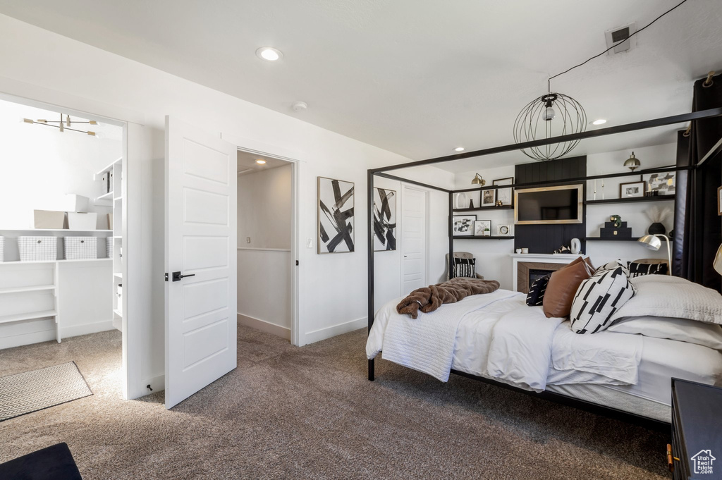 Carpeted bedroom with recessed lighting, baseboards, and a closet