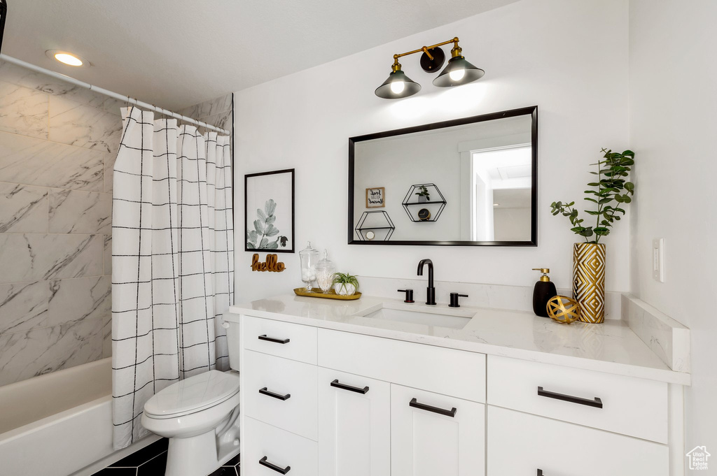Full bathroom with vanity, toilet, and shower / tub combo