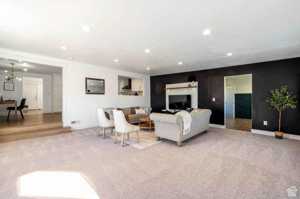 Living area with carpet, recessed lighting, and baseboards