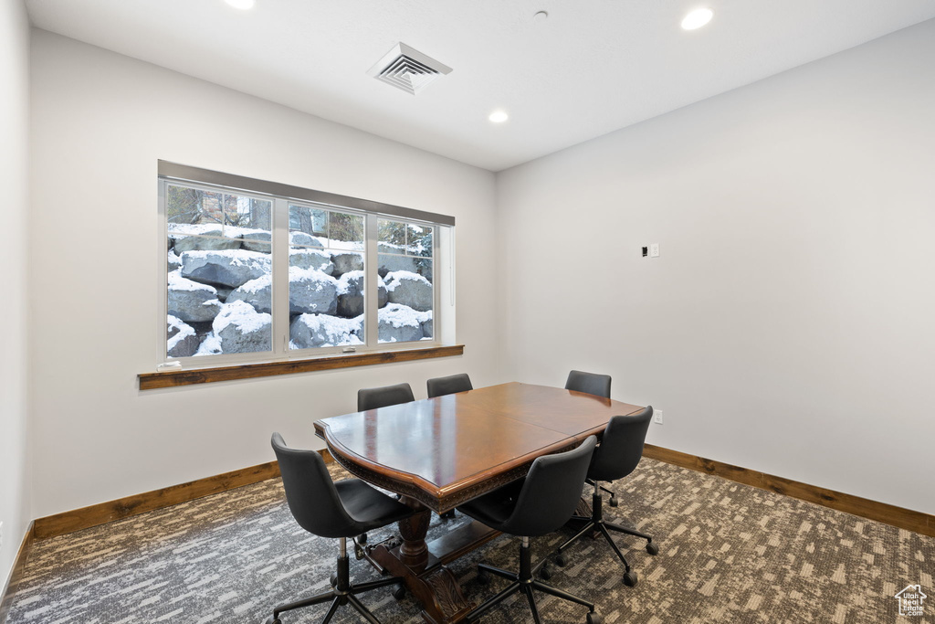 Carpeted dining area with baseboards and recessed lighting