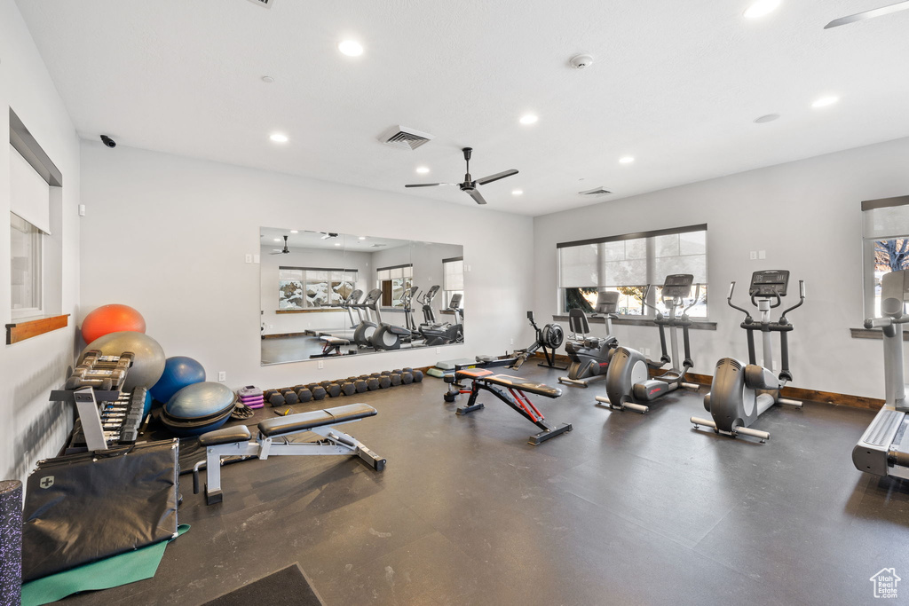 Gym with a ceiling fan, recessed lighting, and baseboards