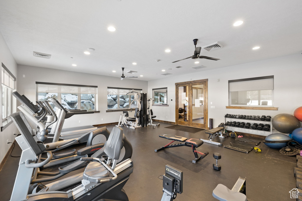 Workout area with ceiling fan, healthy amount of natural light, and recessed lighting