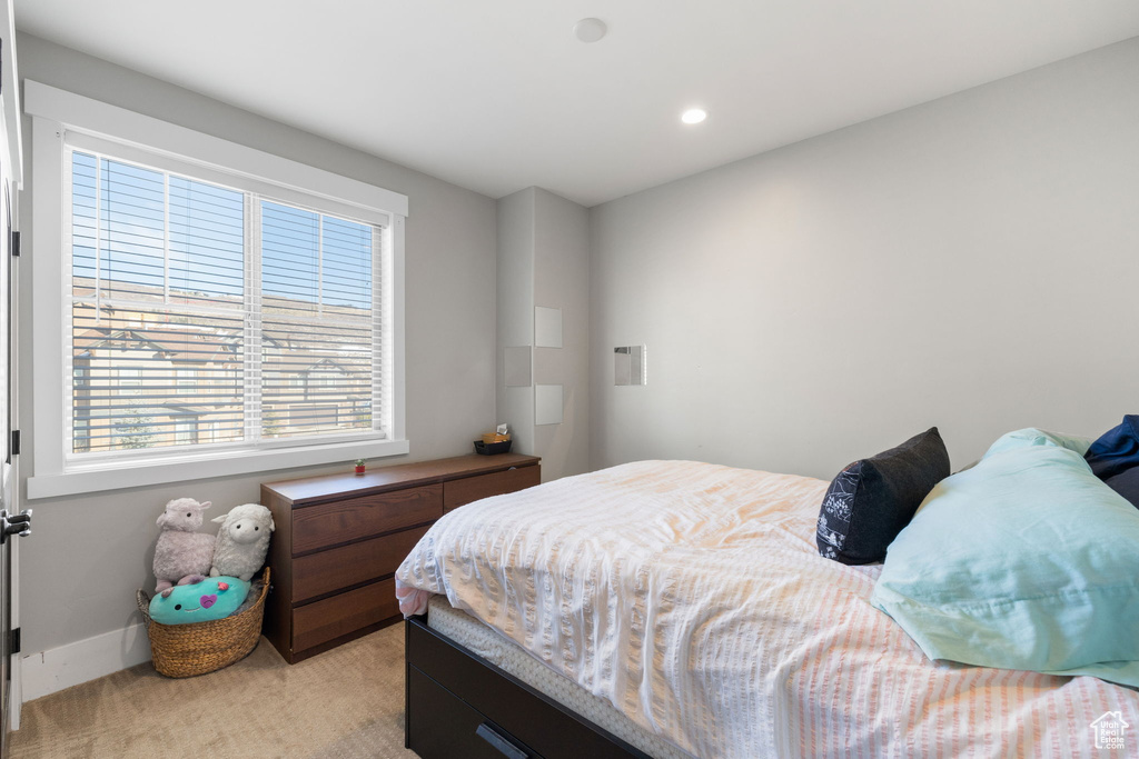 Bedroom with light carpet and recessed lighting