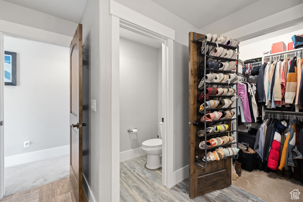 Walk in closet featuring wood finished floors