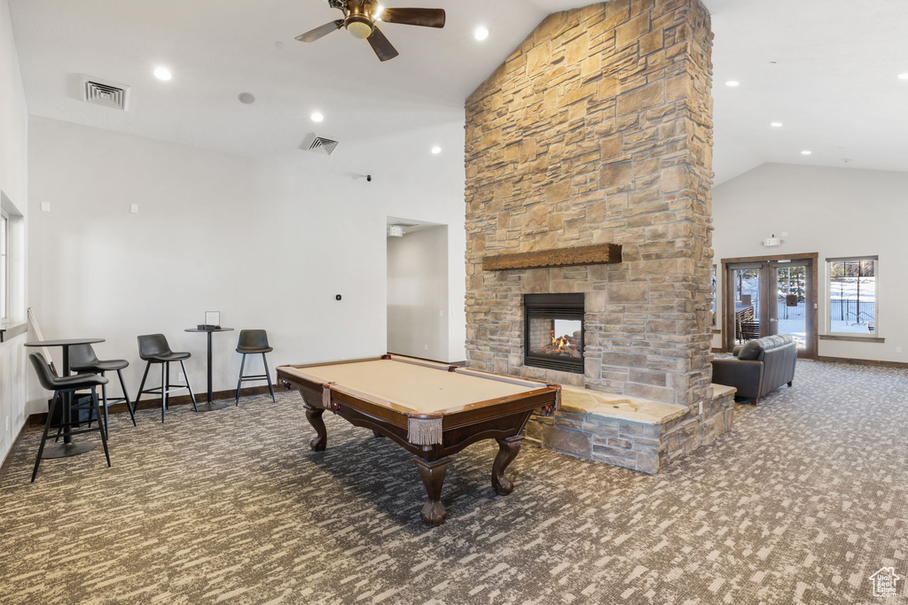 Playroom featuring carpet flooring, a ceiling fan, high vaulted ceiling, billiards, and a fireplace