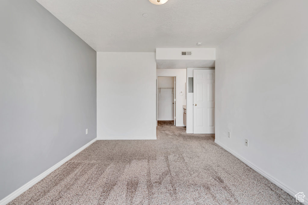 Spare room with carpet and baseboards