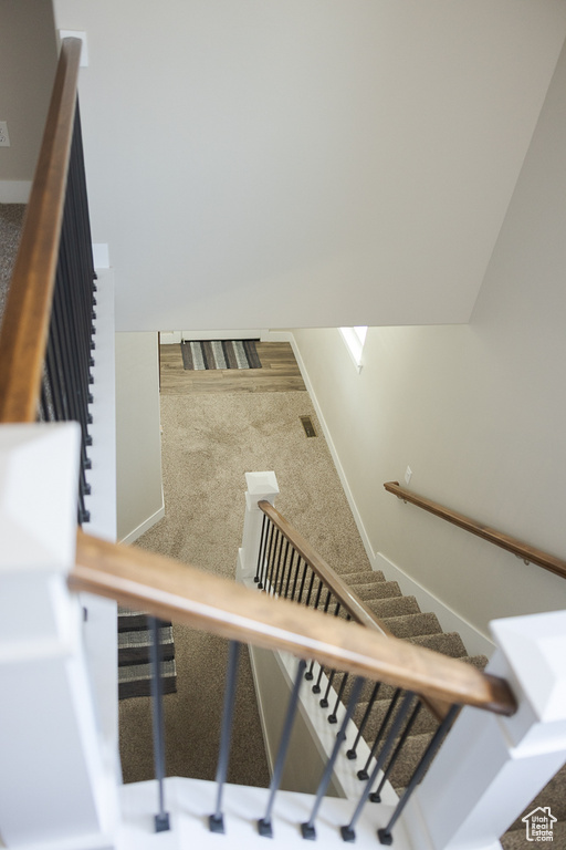 Stairs featuring baseboards and carpet flooring