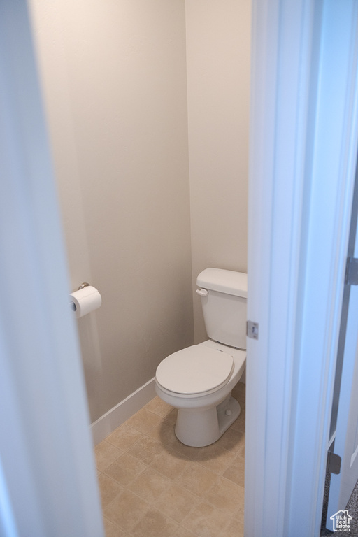 Bathroom featuring toilet and baseboards