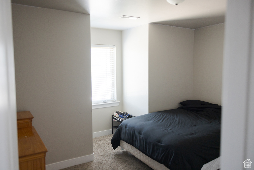 Bedroom featuring carpet flooring and baseboards