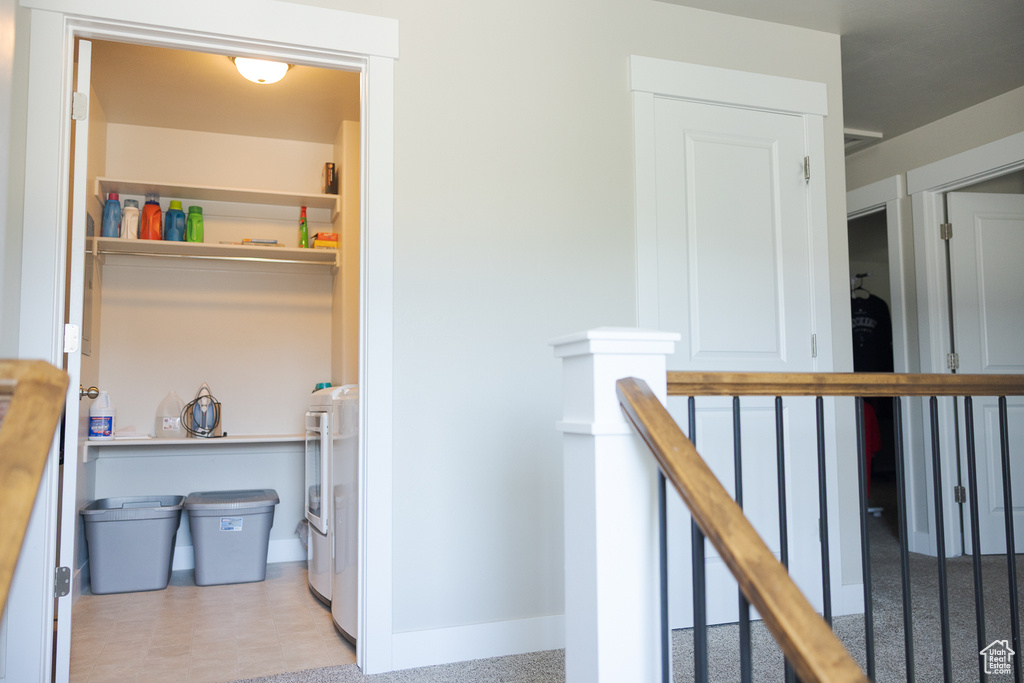 Hallway featuring an upstairs landing and baseboards