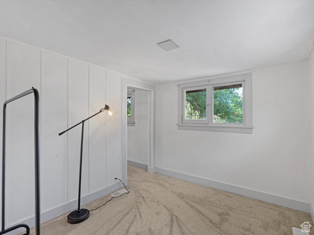 Spare room with light carpet and baseboards