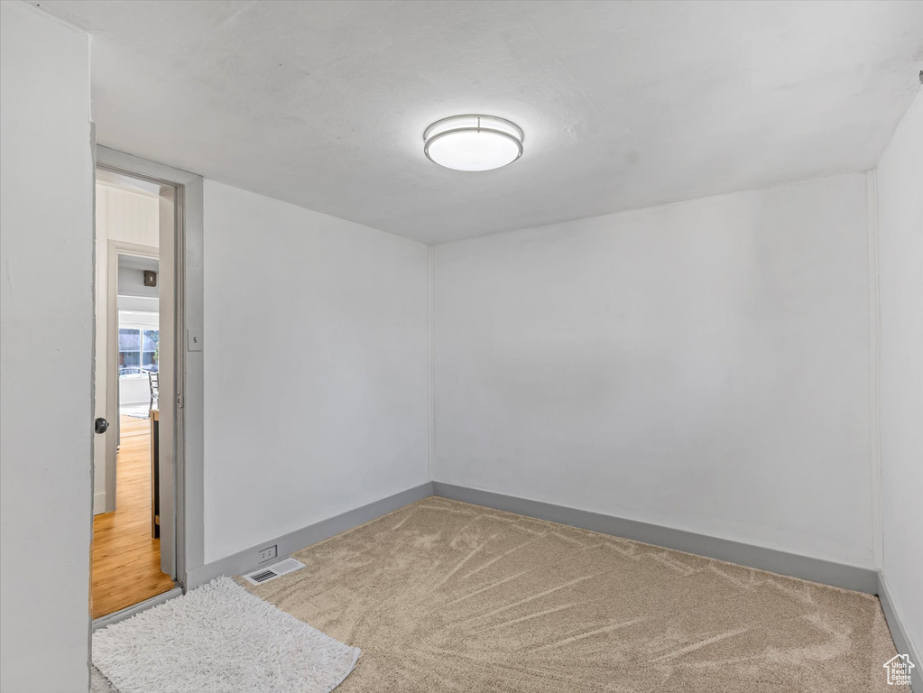 Carpeted spare room with baseboards