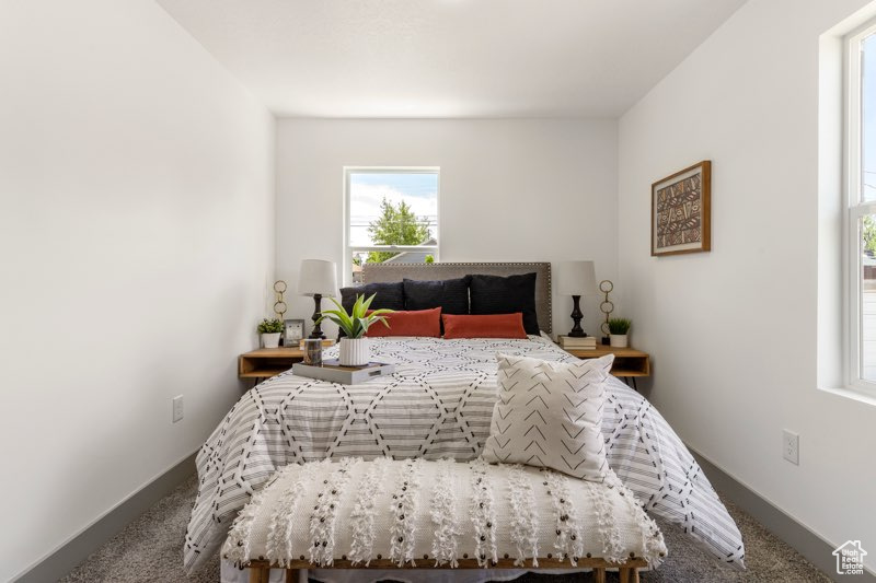 Carpeted bedroom featuring baseboards