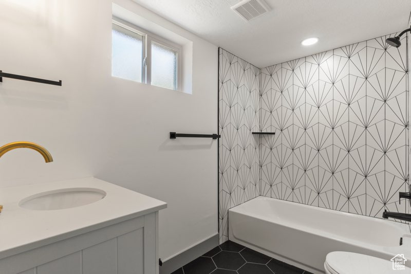 Full bathroom with tile patterned flooring, shower / bathtub combination, vanity, toilet, and recessed lighting