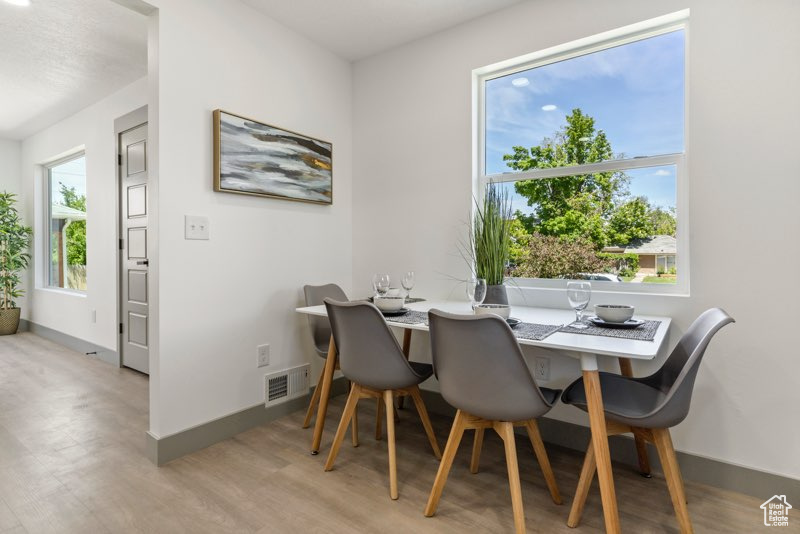 Dining space featuring light wood finished floors and baseboards