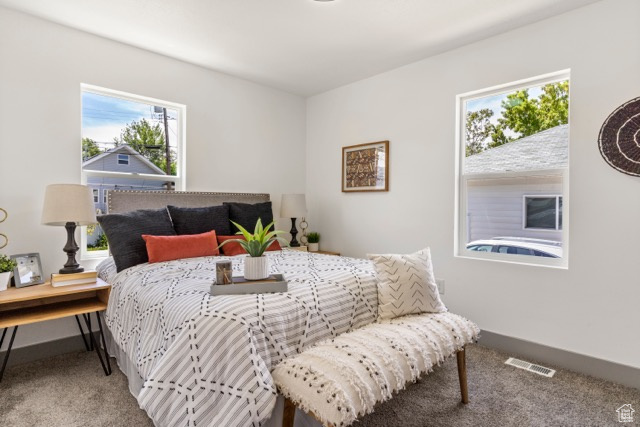 Bedroom featuring carpet flooring and baseboards