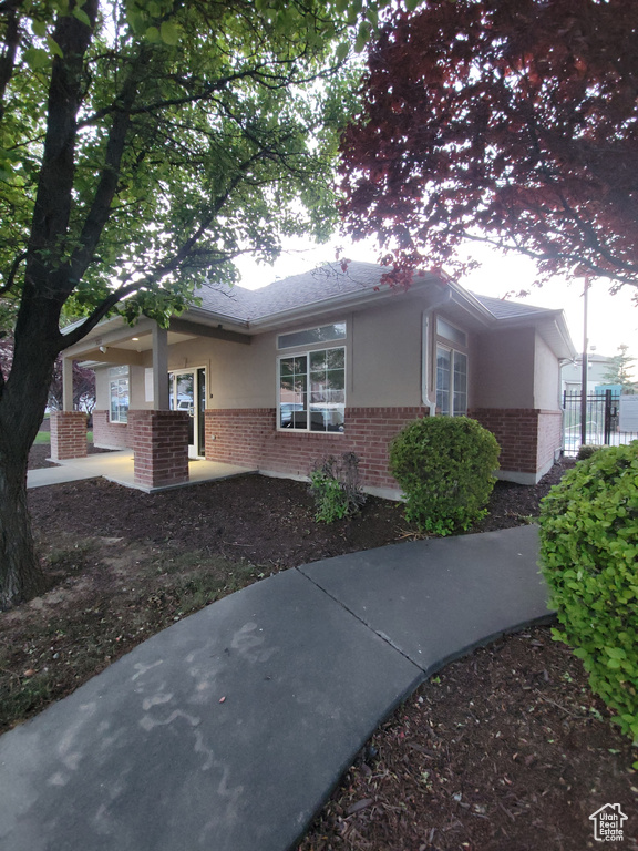 Ranch-style house with brick siding and stucco siding