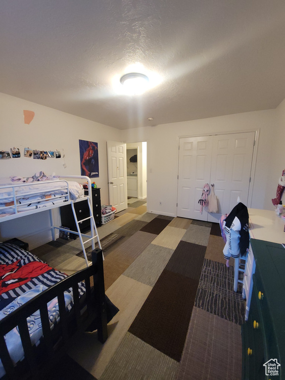 Carpeted bedroom featuring a closet