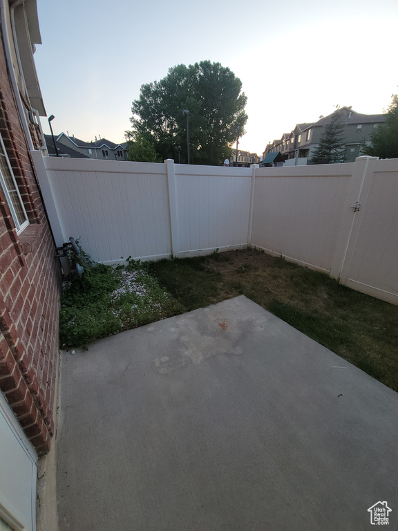 Fenced backyard with a patio