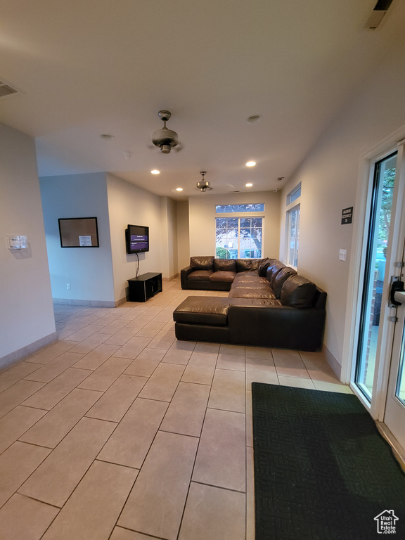 Living area with light tile patterned floors, recessed lighting, and baseboards