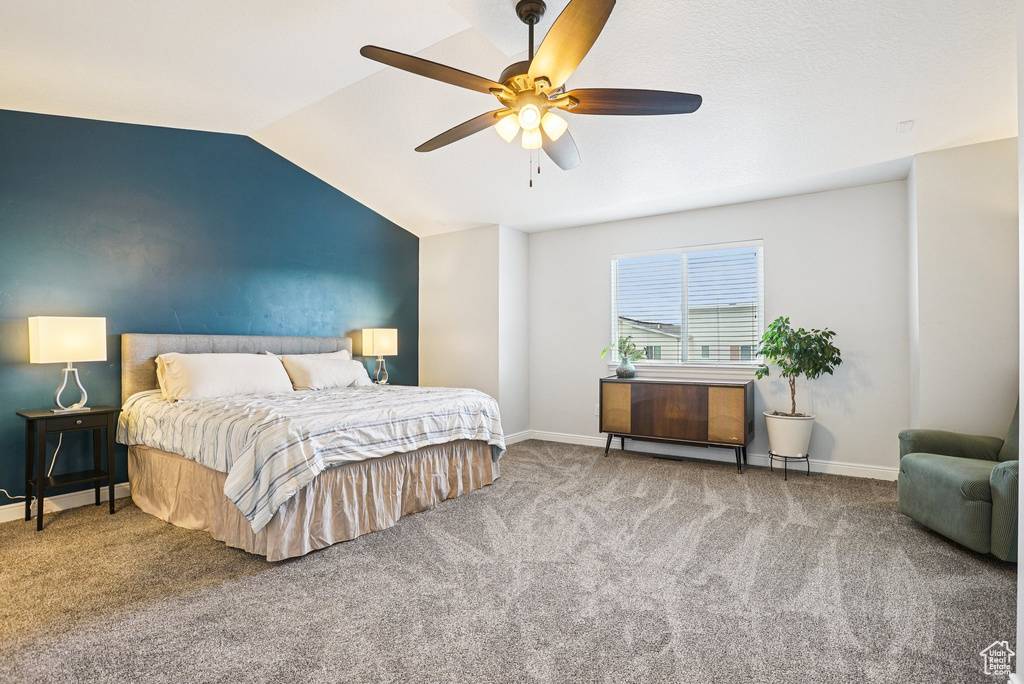 Bedroom with lofted ceiling, carpet flooring, and a ceiling fan