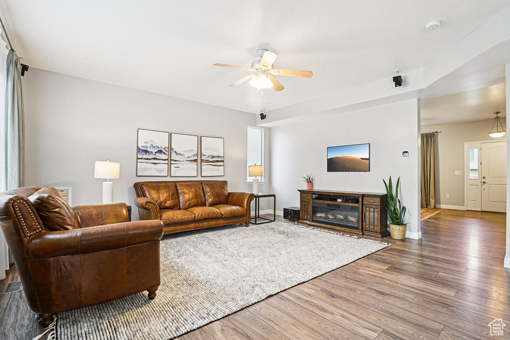 Living room featuring ceiling fan and wood finished floors