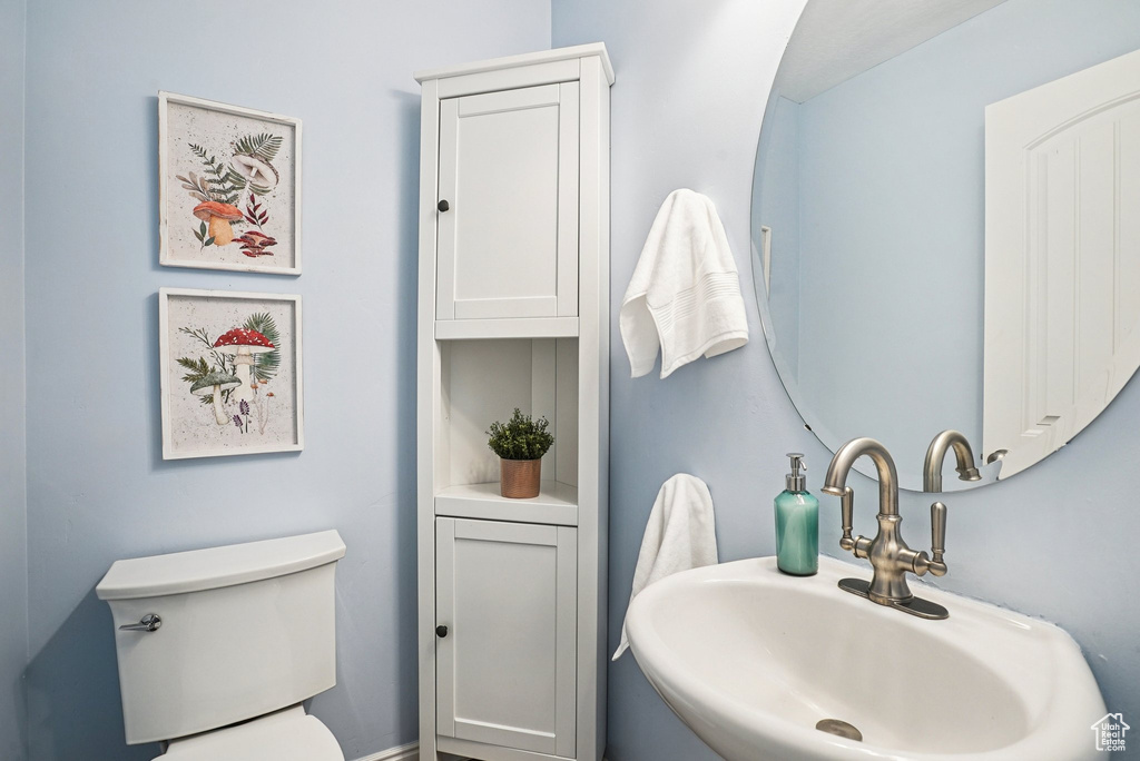 Half bath with a sink and toilet