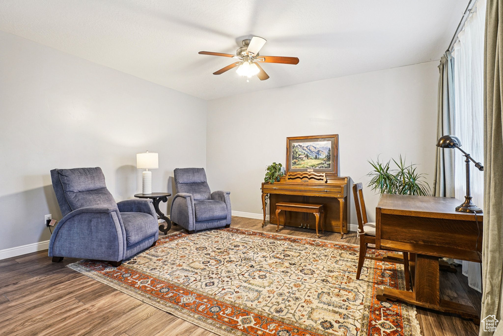 Living area featuring ceiling fan and wood finished floors