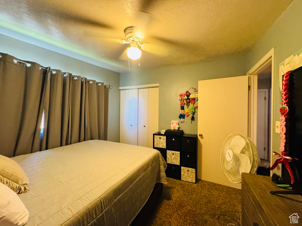 Bedroom with carpet flooring, a closet, and a ceiling fan