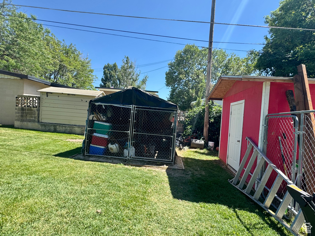 View of grassy yard with an outdoor structure