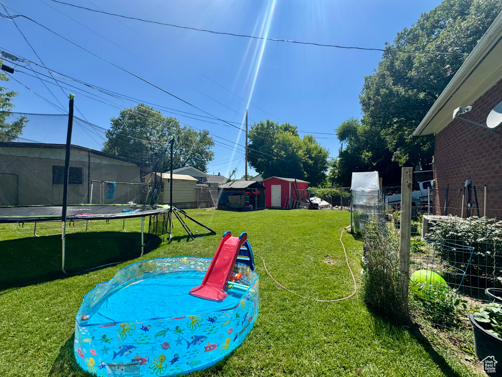 View of yard with a trampoline