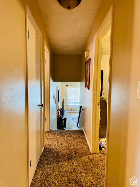 Hallway featuring carpet flooring