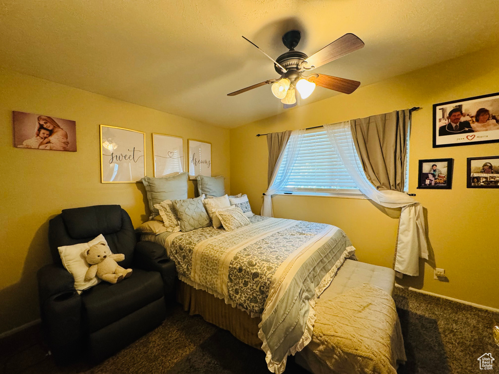 Carpeted bedroom with ceiling fan