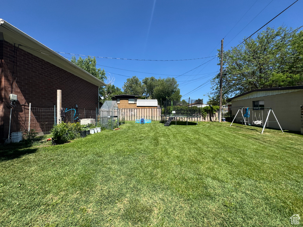 View of yard with a trampoline