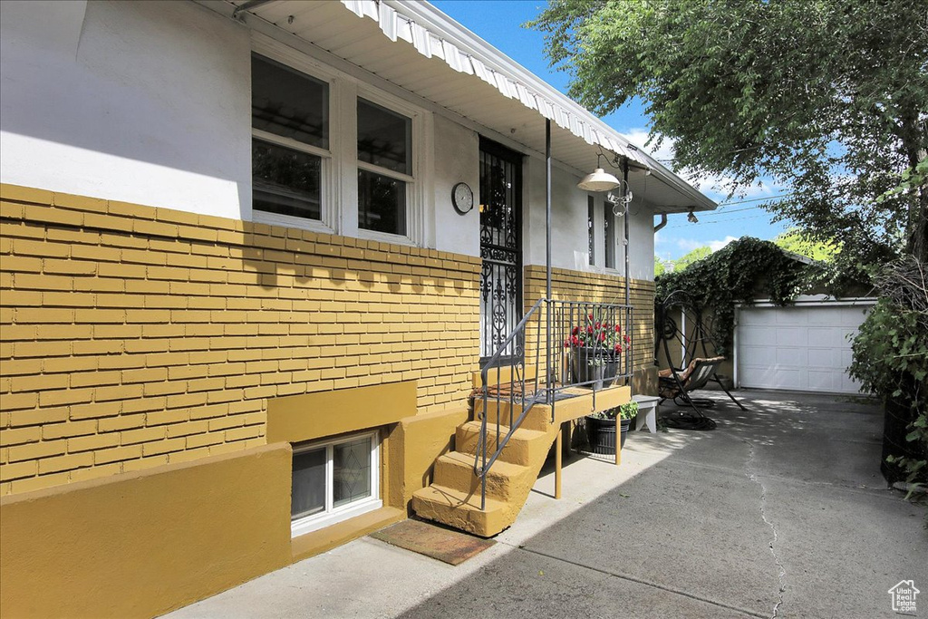Property entrance featuring stucco siding and brick siding