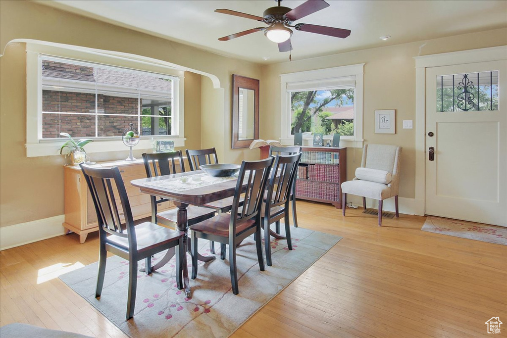 Dining area featuring light wood finished floors, ceiling fan, baseboards, and recessed lighting