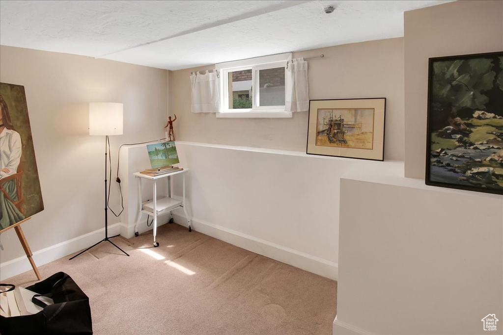 Interior space featuring carpet flooring and baseboards