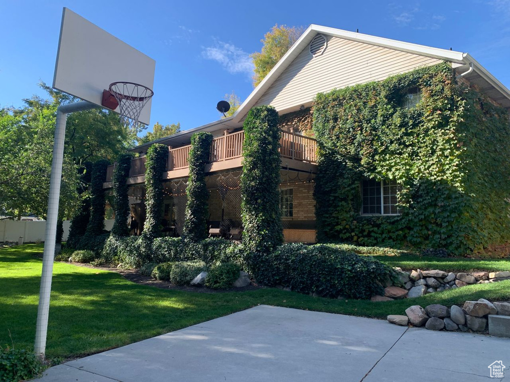 View of side of property with a lawn and a patio