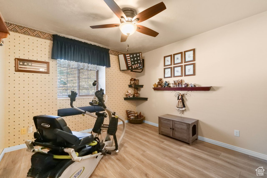 Workout room featuring baseboards, a ceiling fan, and wood finished floors