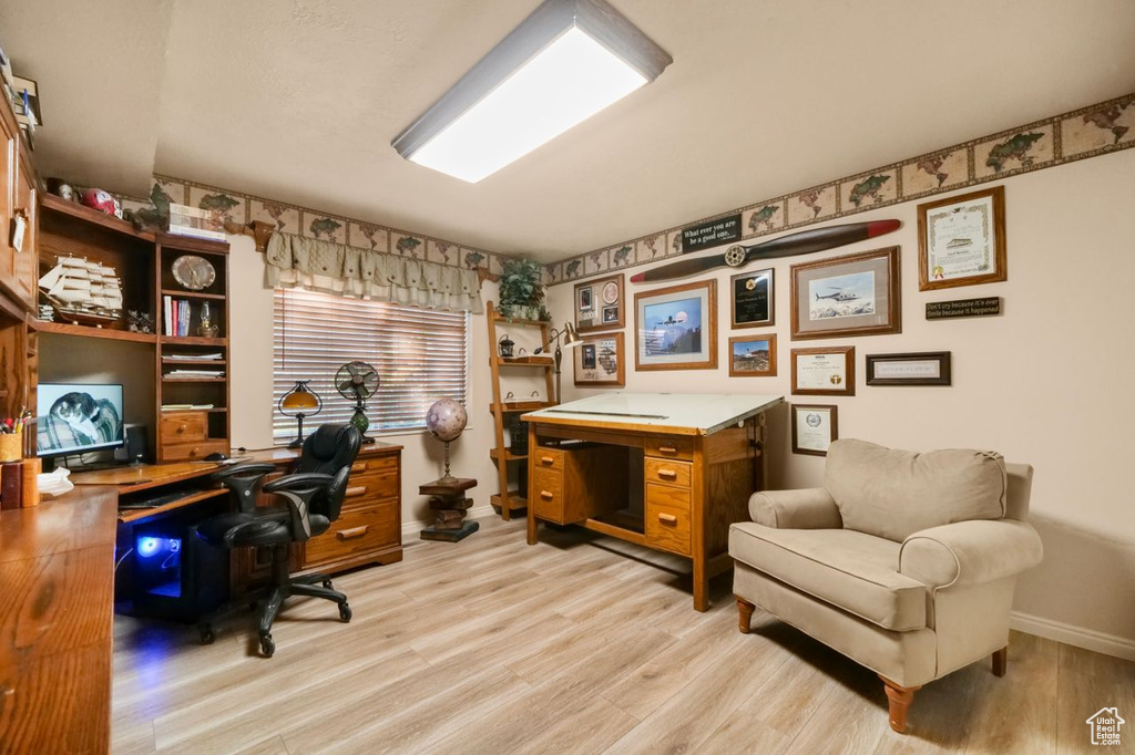Home office featuring light wood-style floors and baseboards