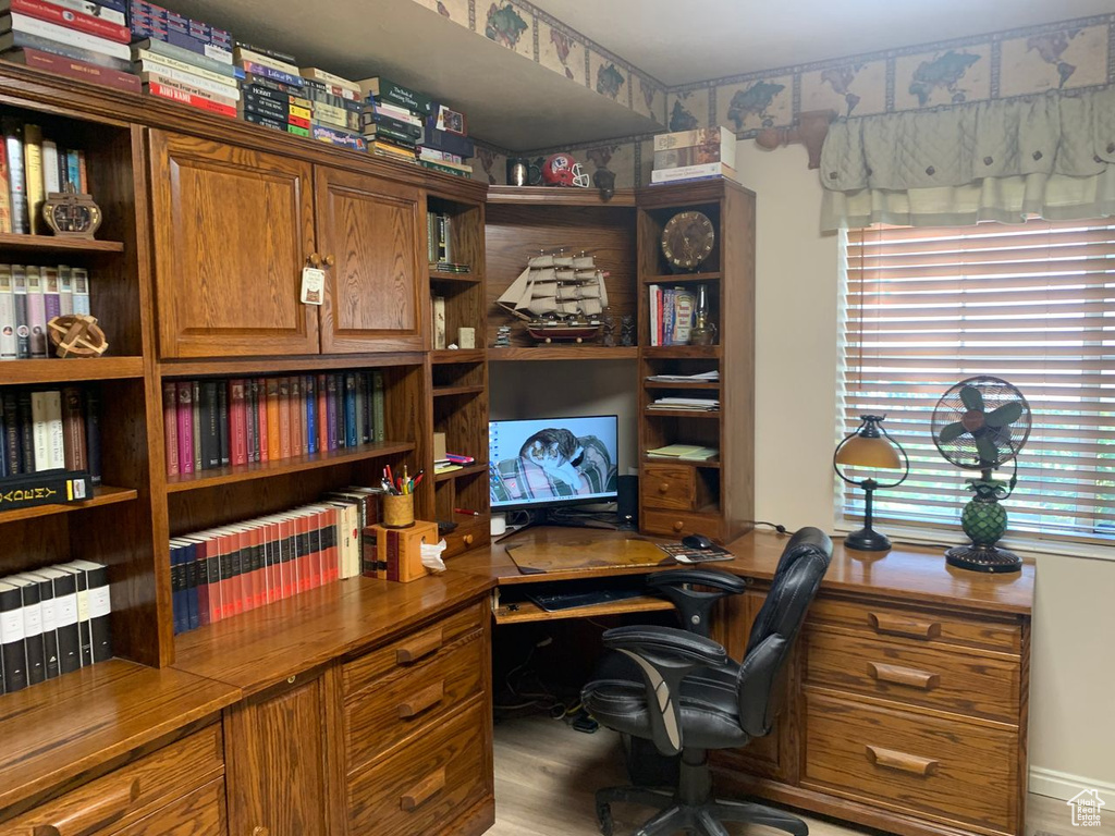 Office with wood finished floors and baseboards