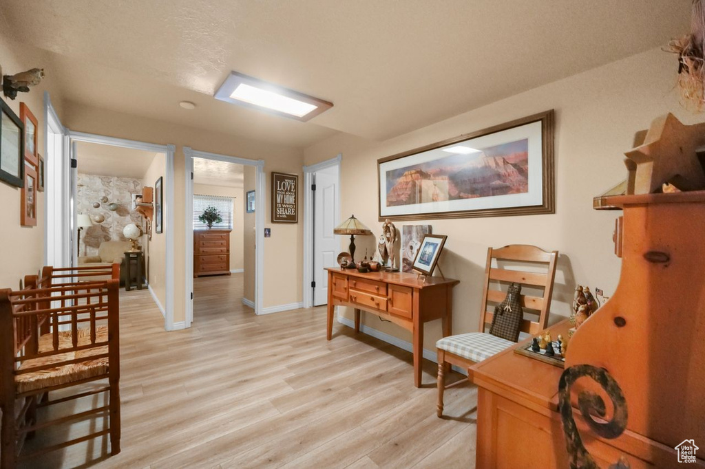 Living area featuring light wood finished floors and baseboards