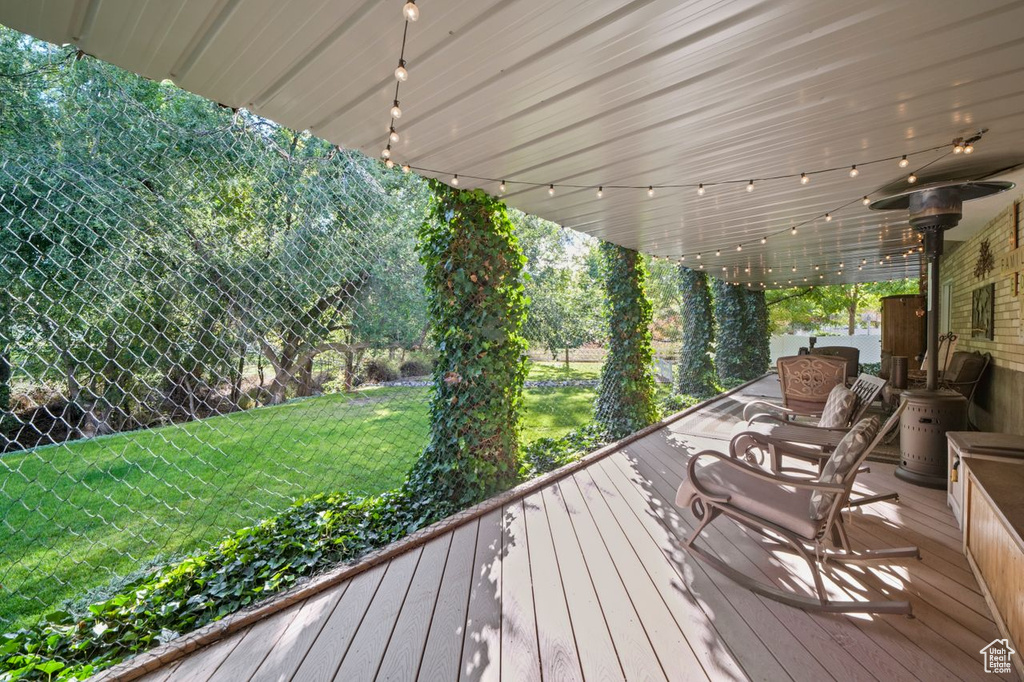Wooden terrace featuring a yard